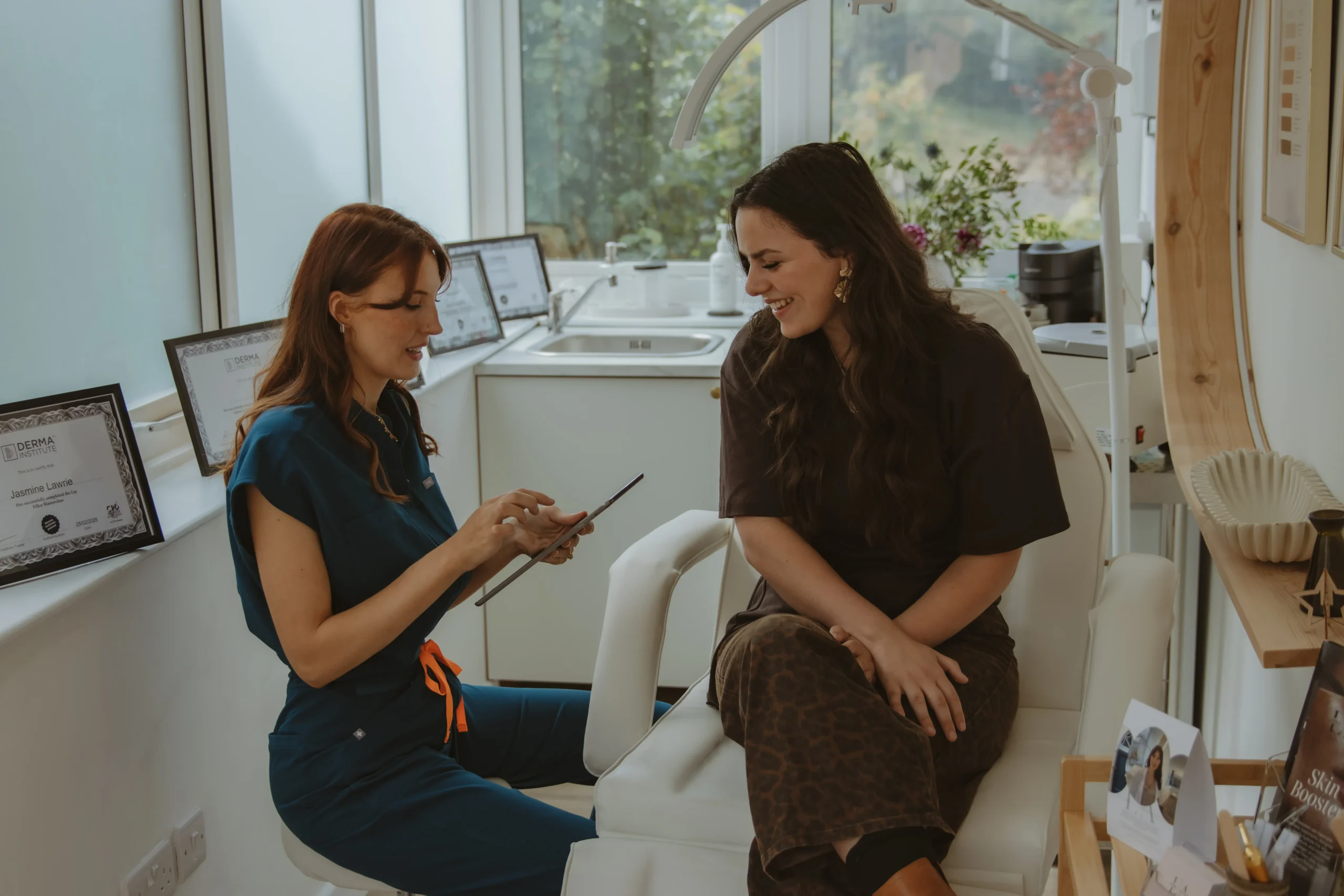 Jasmine consulting with a client at Lawrie Aesthetics in Stroud