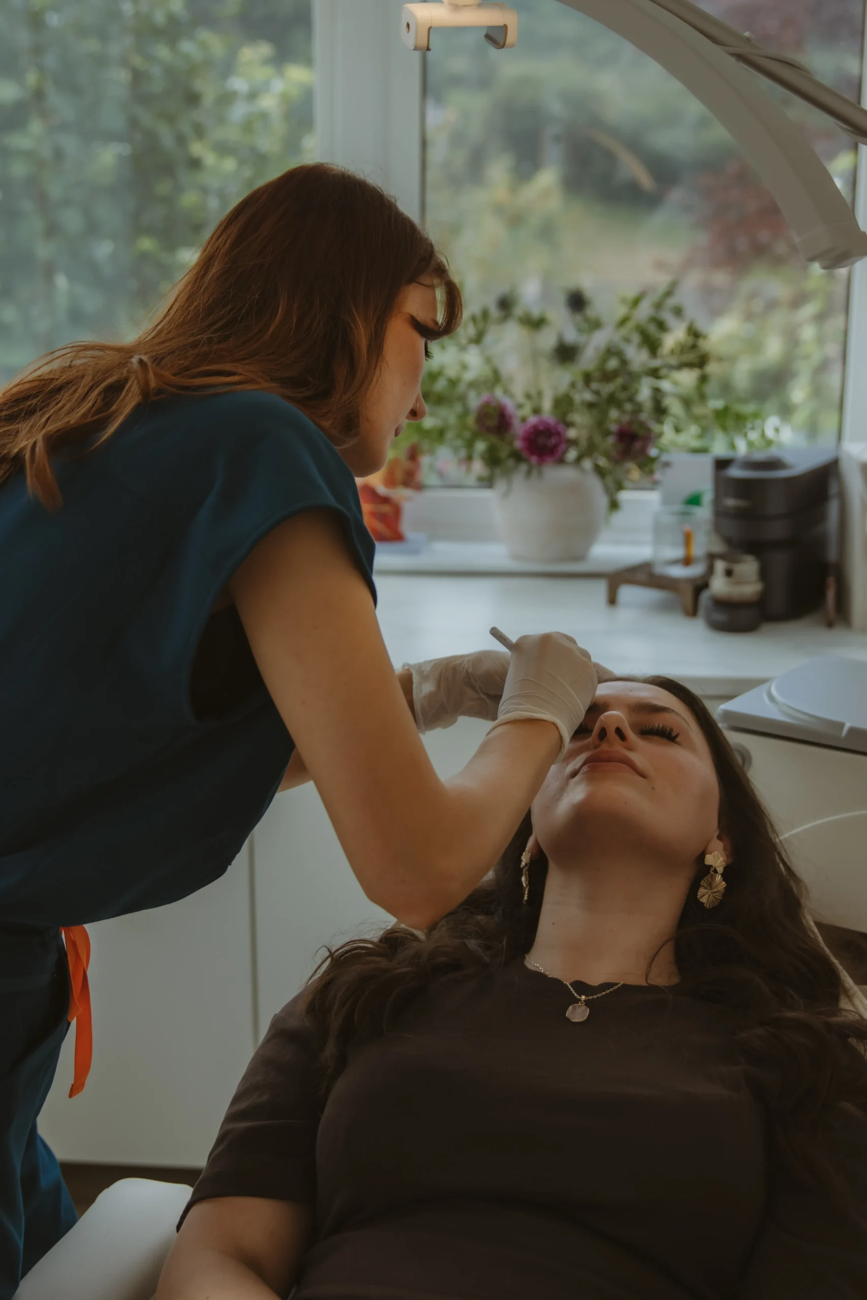 Jasmine performing a precise facial aesthetics treatment