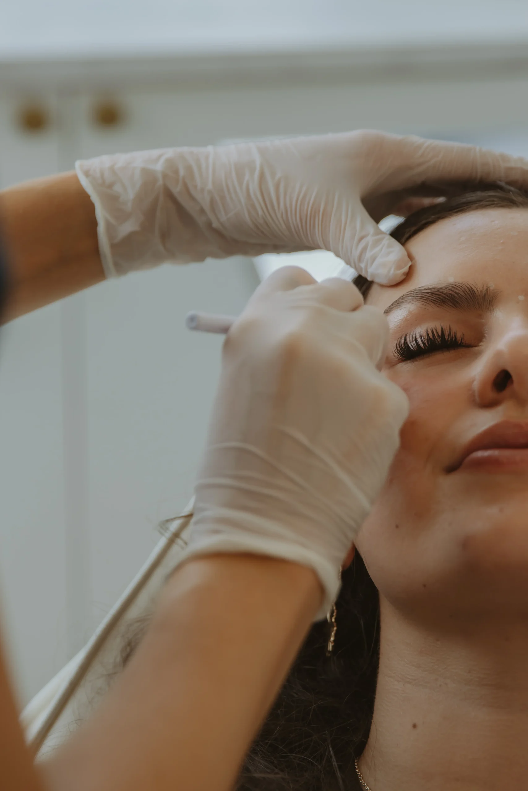 Jasmine administering a precise injectable skin treatment